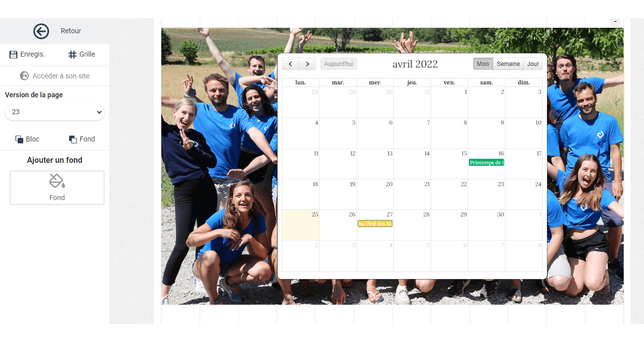 Springly page editor showing an April 2022 calendar in monthly view, overlaid on a group photo page background.